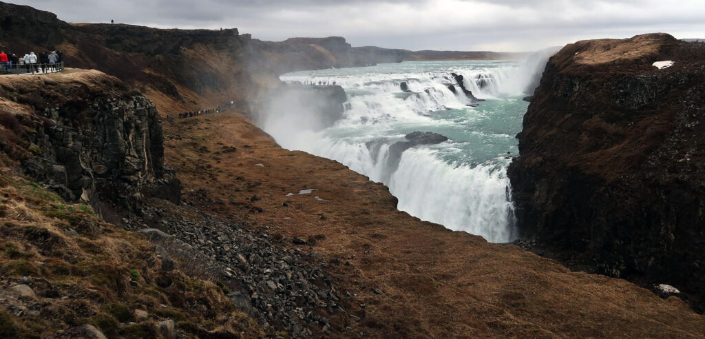 Gullfoss's twin cascades funnel 140 cubic meters of water into a deep ravine every second.