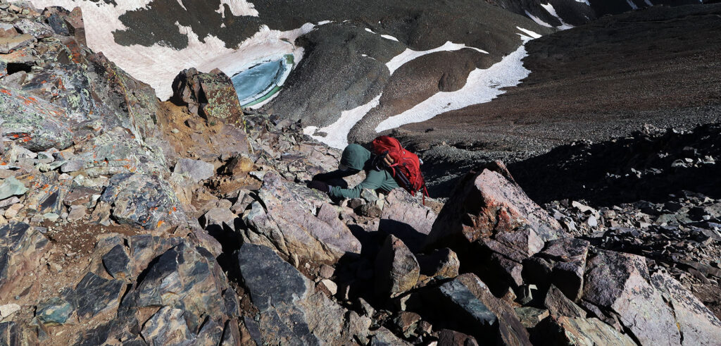 Heading up a light scrambly bit of Castle Peak.