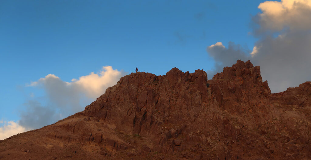 A lone scrambler on Wetterhorn Peak's rugged ridgeline.