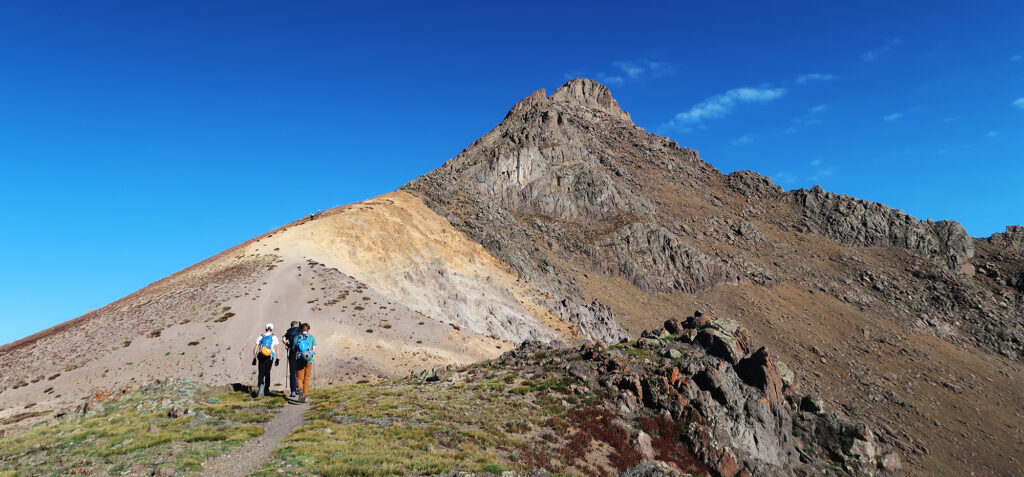 A trio of climbers approaches the peak.