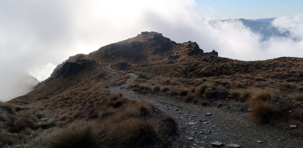 Morning clouds form beneath the high ridgeline.