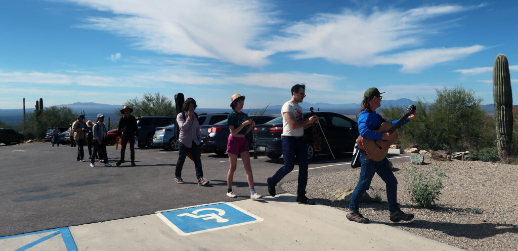 A merry band of performance artists off to serenade the desert in Saguaro NP, near Wasson Peak.