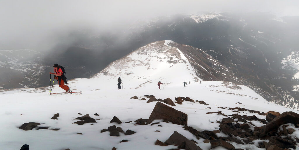 Skinners pushing up the ridgeline, en route to skiing Quandary.