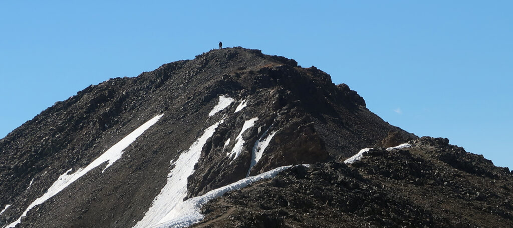 A lone hiker stands atop Missouri Mountain.