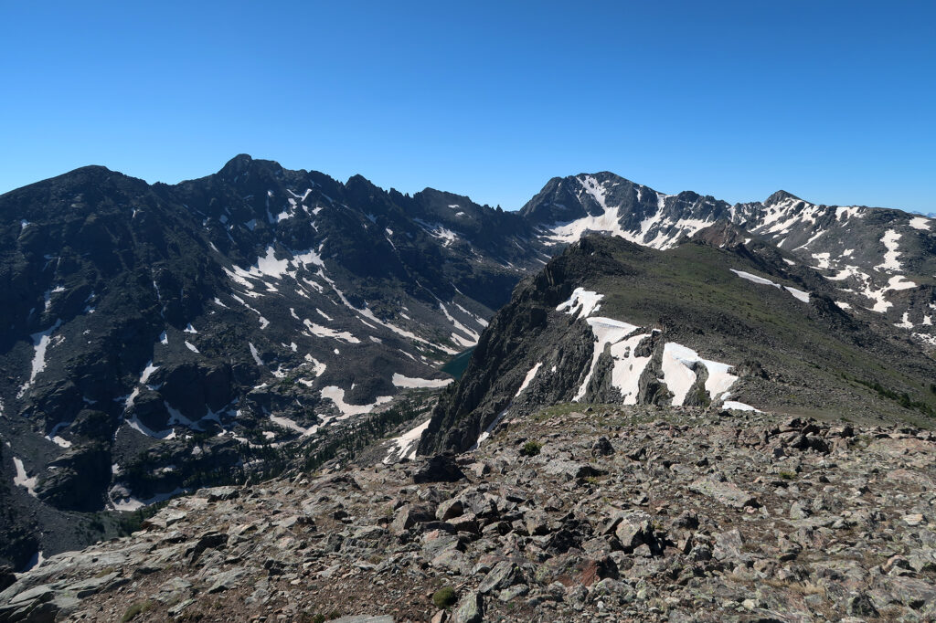 Views from New York Mountain's craggy cirque, and other nearby summits like Gold Dust Peak.