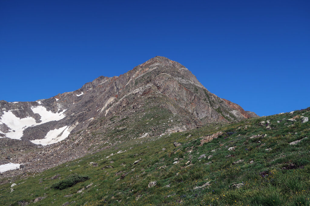 A view up the crux of Father Dyer Peak's East Ridge, from the grassy flat expanse about a third of the way up.