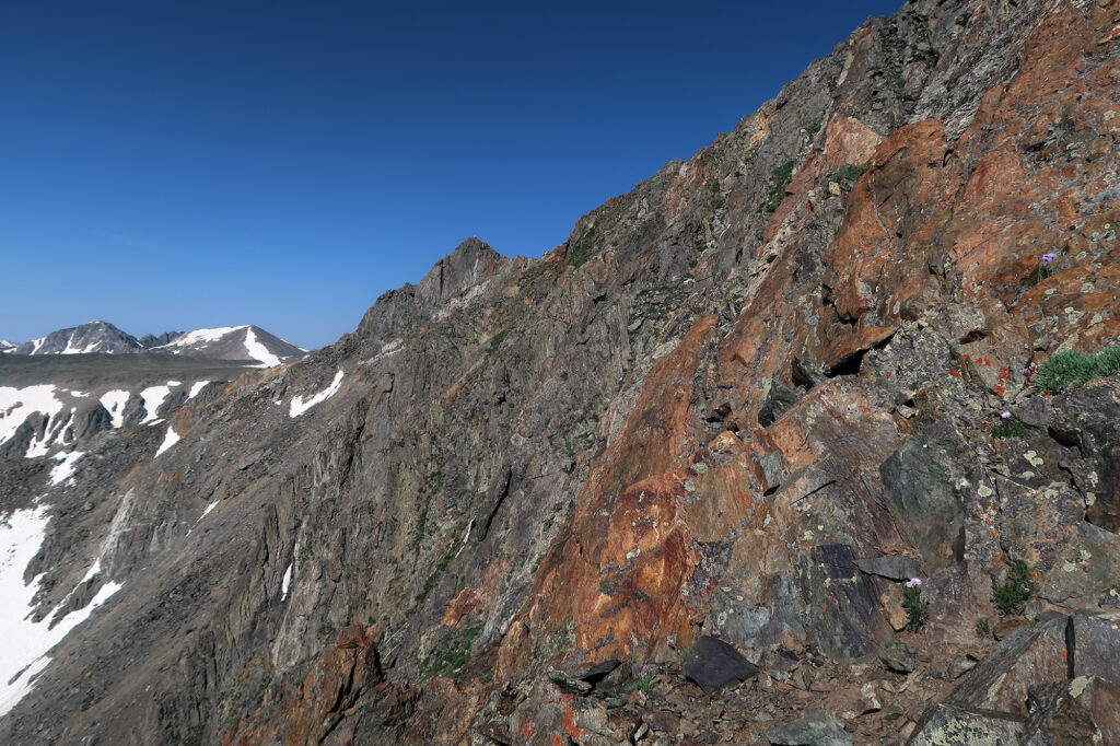 Rusty red rocks on some of the final steep pitches of Father Dyer Peak's East RIdge.