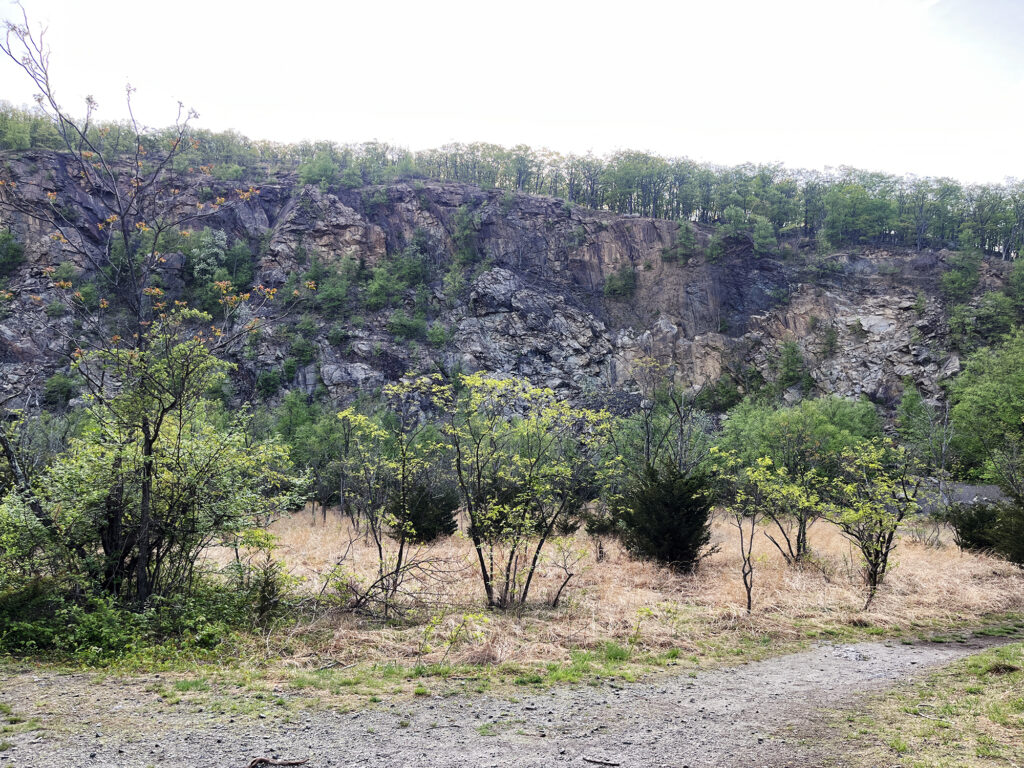 Early on, the ascent runs past an old rock quarry dug into the side of the mountain.