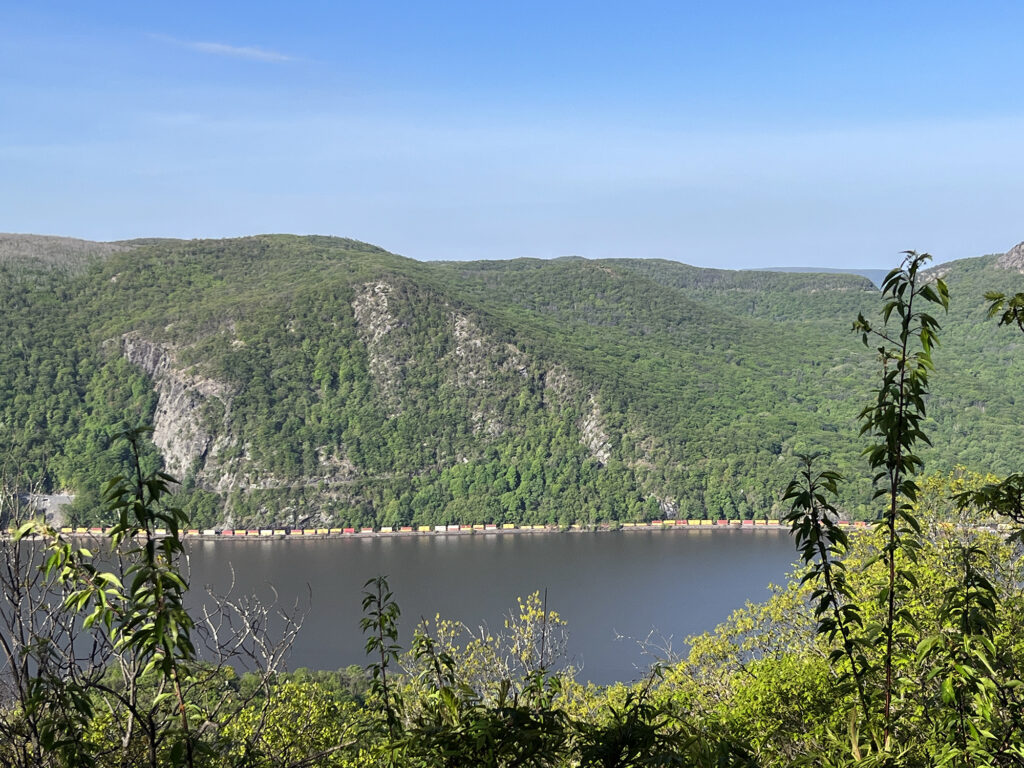 A long freight train snakes along the Hudson's western bank.